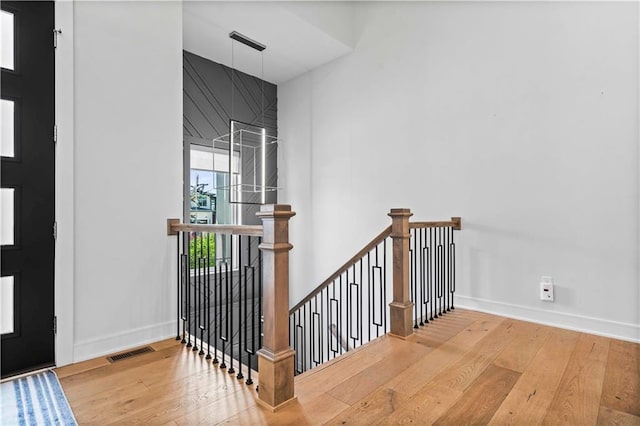 stairs featuring hardwood / wood-style floors