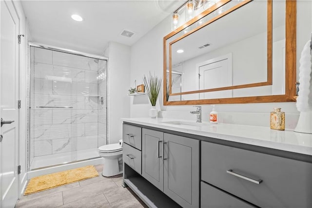 bathroom with tile patterned flooring, an enclosed shower, vanity, and toilet