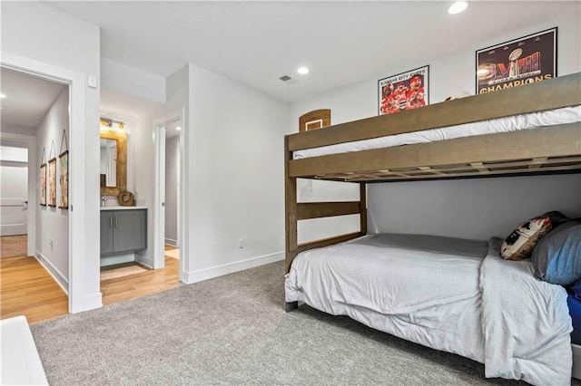 carpeted bedroom featuring ensuite bathroom