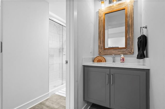 bathroom featuring a shower with door, vanity, and tile patterned flooring