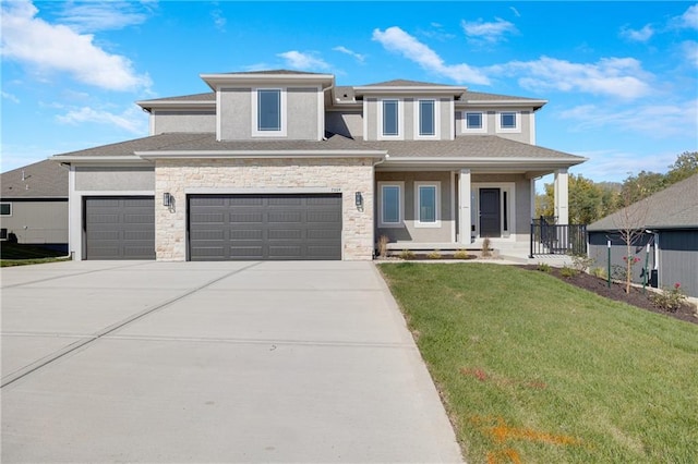 prairie-style home with covered porch, a garage, and a front lawn