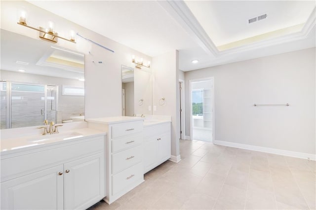 bathroom with vanity, tile patterned flooring, an enclosed shower, and a raised ceiling