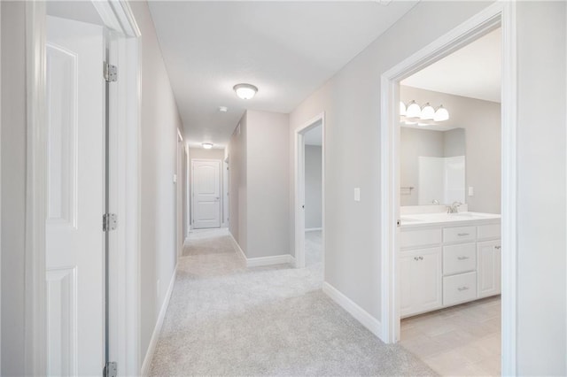 hallway with light colored carpet