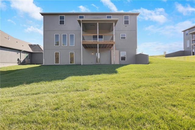 rear view of property featuring cooling unit and a lawn