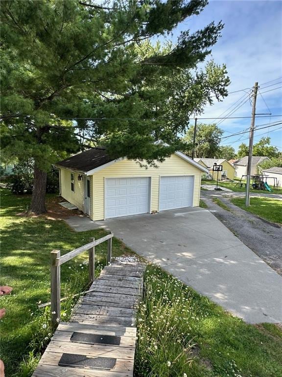 exterior space with a garage, a front yard, and an outdoor structure