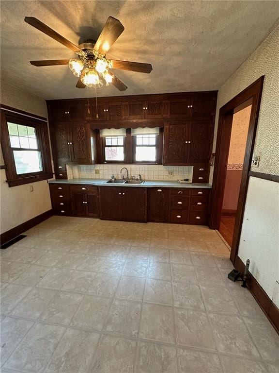 kitchen featuring ceiling fan, plenty of natural light, and tasteful backsplash