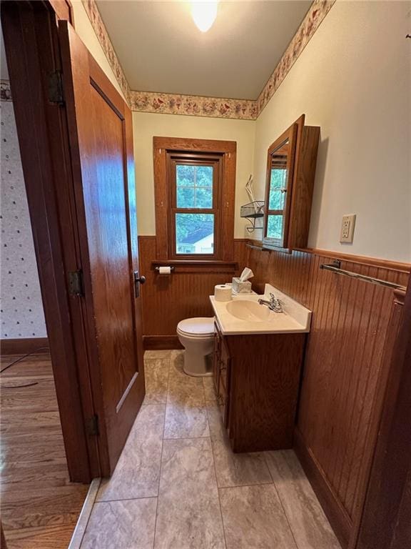 bathroom with tile floors, toilet, and vanity with extensive cabinet space