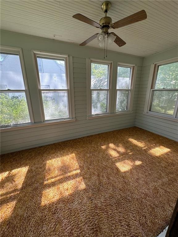 unfurnished sunroom with ceiling fan and a healthy amount of sunlight