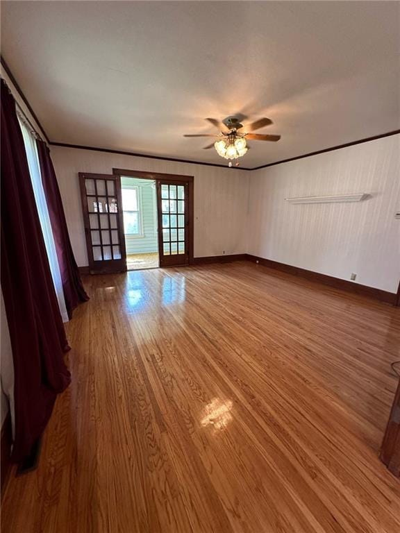 empty room featuring hardwood / wood-style flooring and ceiling fan