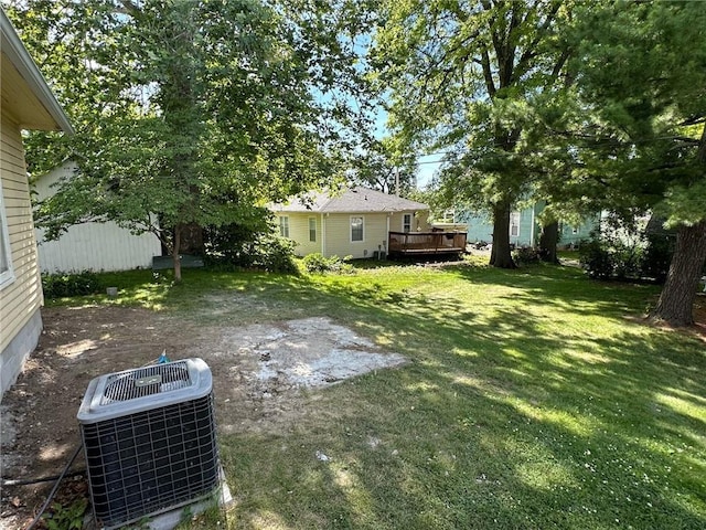 view of yard with a deck and central AC