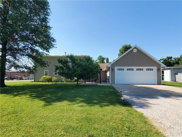 view of front of property with a garage and a front yard