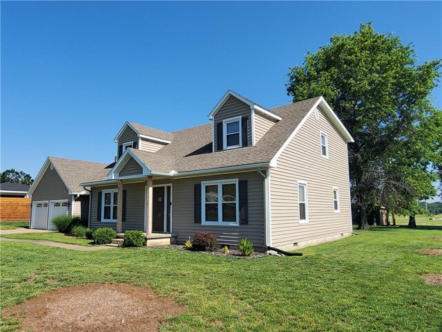 501 Meadow Ln, Fort Scott, KS 66701 - cape cod home with a garage and a front lawn