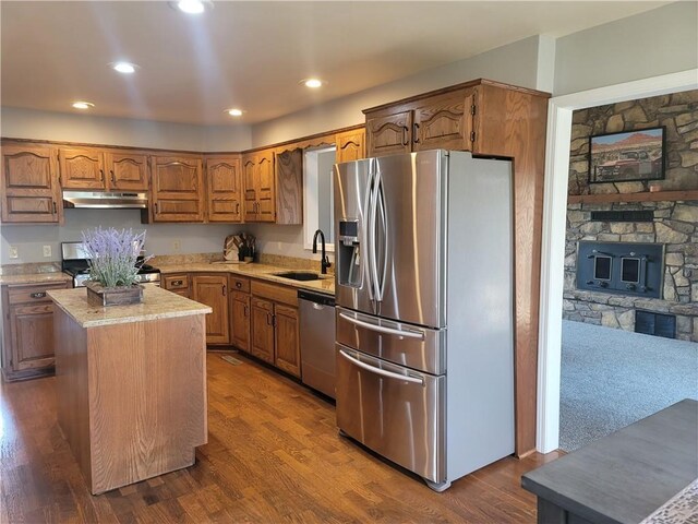 501 Meadow Ln, Fort Scott, KS 66701 - kitchen featuring sink, appliances with stainless steel finishes, dark hardwood / wood-style floors, a fireplace, and a kitchen island