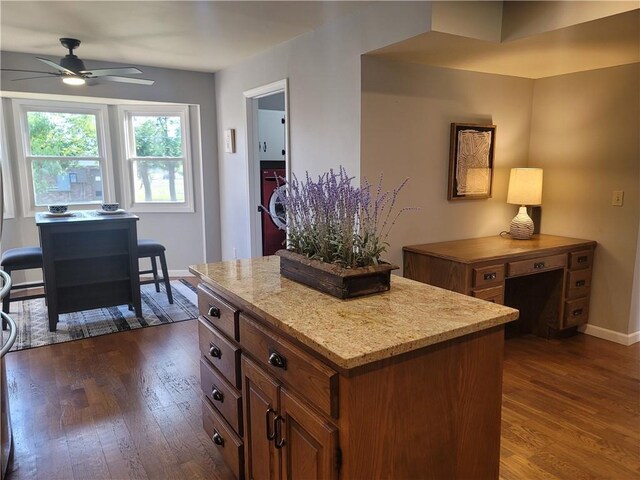 501 Meadow Ln, Fort Scott, KS 66701 - kitchen featuring ceiling fan, a kitchen island, and dark hardwood / wood-style flooring