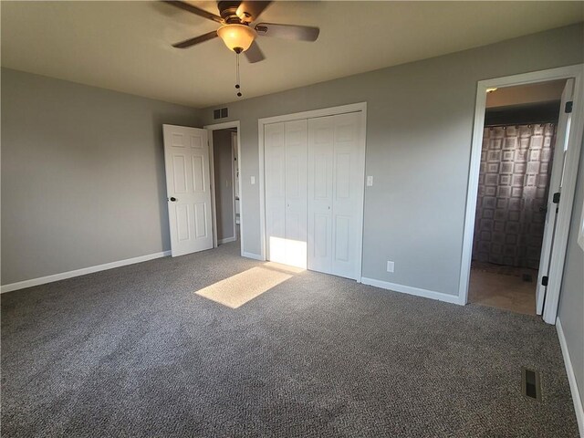 501 Meadow Ln, Fort Scott, KS 66701 - unfurnished bedroom with ceiling fan, ensuite bathroom, a closet, and dark colored carpet
