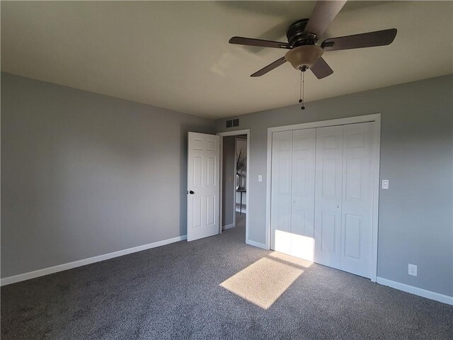 501 Meadow Ln, Fort Scott, KS 66701 - unfurnished bedroom with a closet, ceiling fan, and dark colored carpet