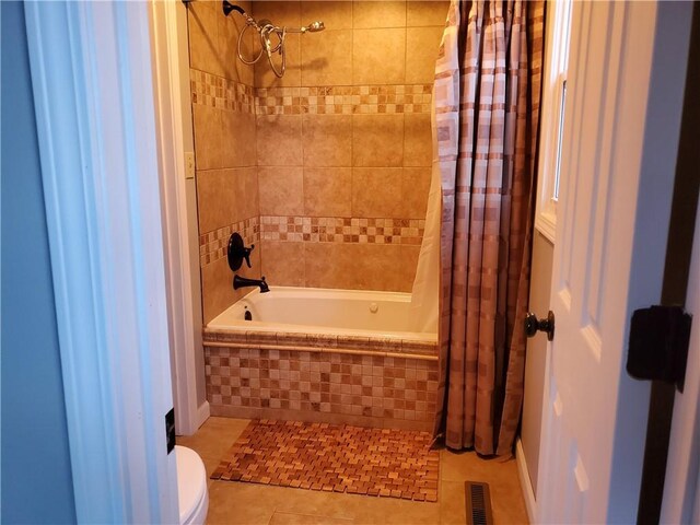 501 Meadow Ln, Fort Scott, KS 66701 - bathroom featuring tile patterned floors, shower / bath combination with curtain, and toilet