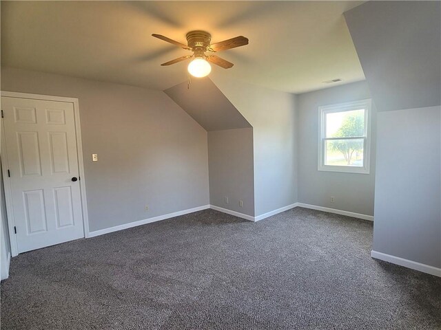 501 Meadow Ln, Fort Scott, KS 66701 - additional living space featuring dark carpet, vaulted ceiling, and ceiling fan