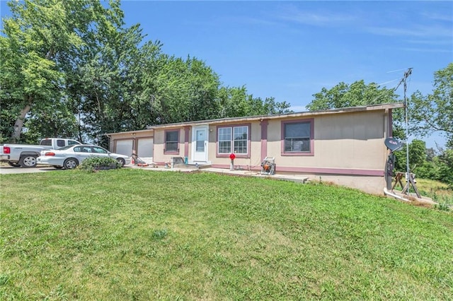 view of front of house with a garage and a front yard