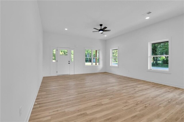 empty room featuring light wood-type flooring and ceiling fan