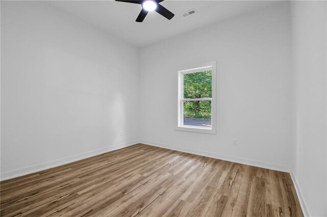 unfurnished room with ceiling fan and light wood-type flooring