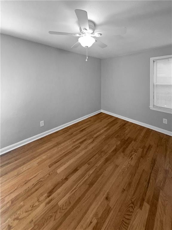 spare room featuring hardwood / wood-style floors and ceiling fan