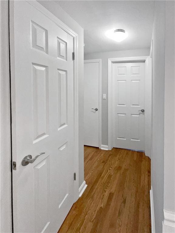 corridor with hardwood / wood-style floors