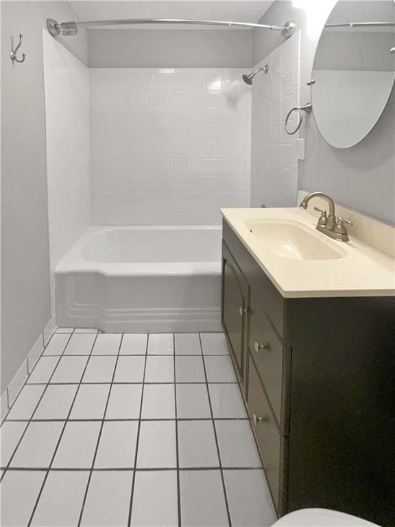 full bathroom featuring tile patterned flooring, vanity, toilet, and tiled shower / bath