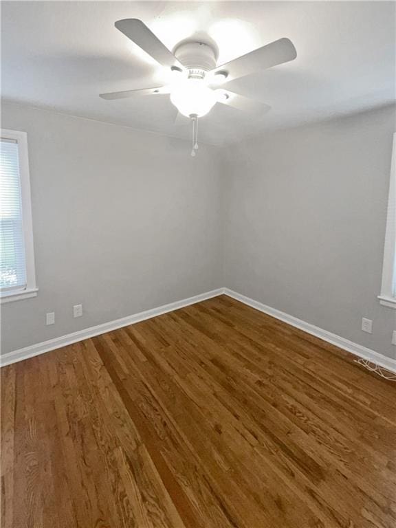 empty room with wood-type flooring and ceiling fan