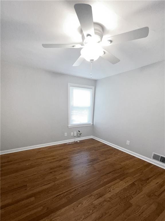 spare room featuring ceiling fan and dark hardwood / wood-style flooring