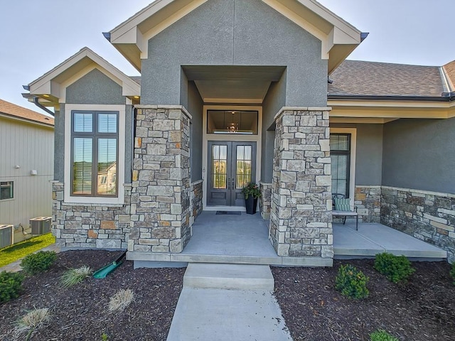 8013 Millridge St, Shawnee, KS 66220 - property entrance with french doors, stucco siding, and stone siding