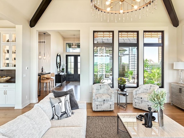 8013 Millridge St, Shawnee, KS 66220 - living room with a notable chandelier, french doors, visible vents, light wood-style floors, and beam ceiling
