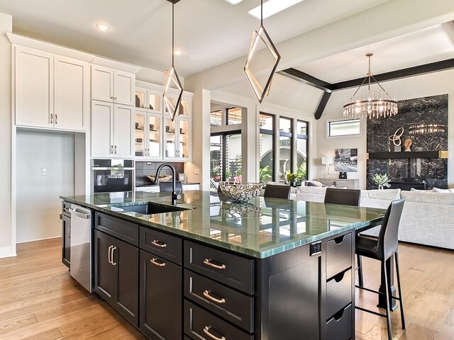 8013 Millridge St, Shawnee, KS 66220 - kitchen featuring appliances with stainless steel finishes, an island with sink, open floor plan, and a sink