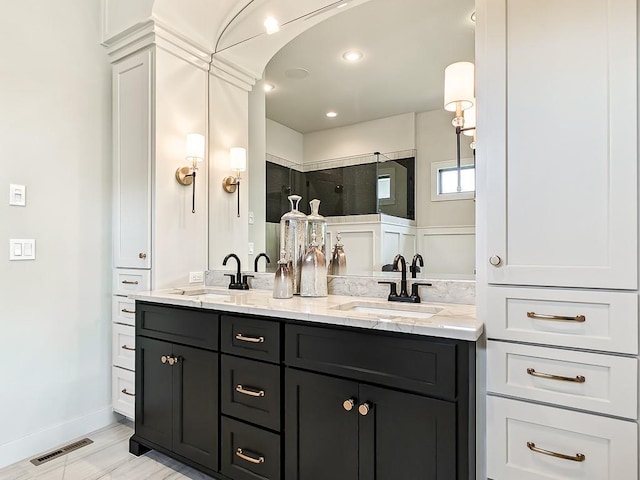 8013 Millridge St, Shawnee, KS 66220 - full bathroom with double vanity, visible vents, a tile shower, and a sink