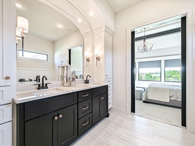 8013 Millridge St, Shawnee, KS 66220 - ensuite bathroom with a sink, double vanity, connected bathroom, and a notable chandelier