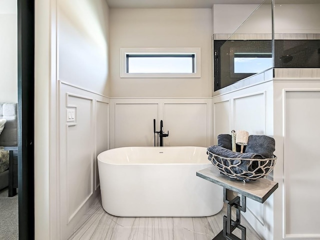 8013 Millridge St, Shawnee, KS 66220 - bathroom featuring a decorative wall, a wainscoted wall, and a freestanding tub