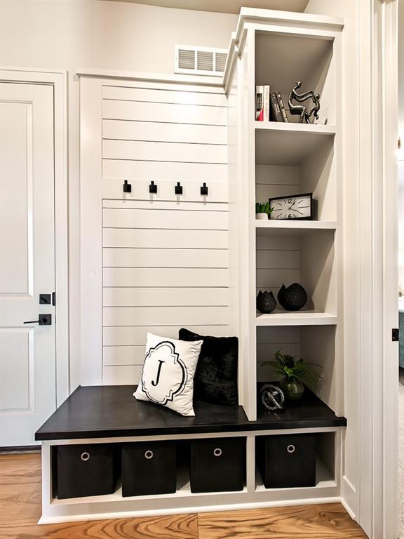8013 Millridge St, Shawnee, KS 66220 - mudroom with visible vents, built in features, and wood finished floors