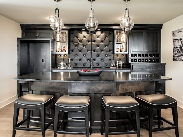 8013 Millridge St, Shawnee, KS 66220 - bar featuring baseboards, decorative backsplash, a dry bar, and decorative light fixtures