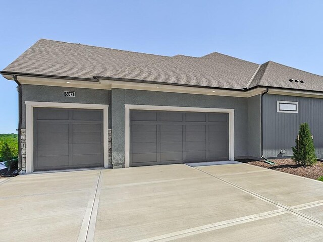 8013 Millridge St, Shawnee, KS 66220 - exterior space with concrete driveway, a shingled roof, and a garage