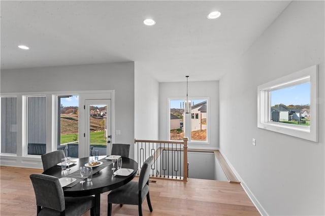 dining room with hardwood / wood-style floors and an inviting chandelier