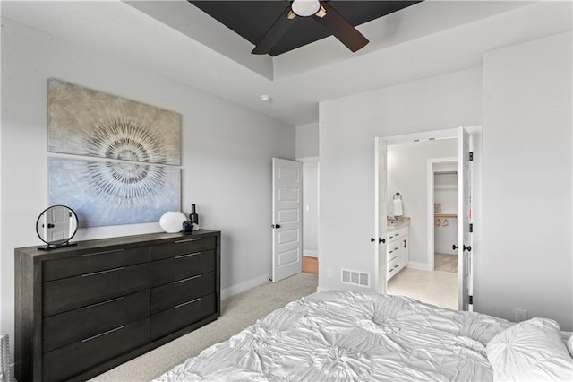 carpeted bedroom featuring ceiling fan and connected bathroom