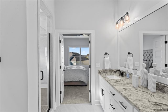 bathroom featuring walk in shower, ceiling fan, vanity, and tile patterned flooring