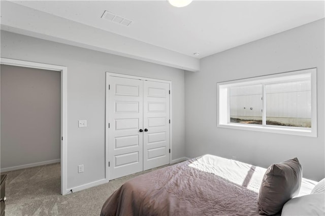 carpeted bedroom with a closet