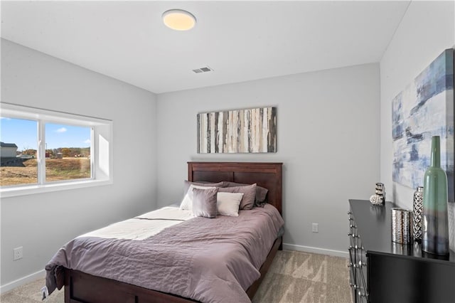 bedroom featuring light colored carpet