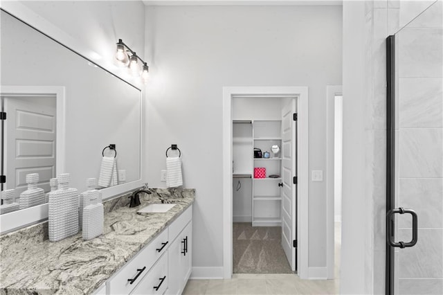 bathroom featuring vanity and an enclosed shower