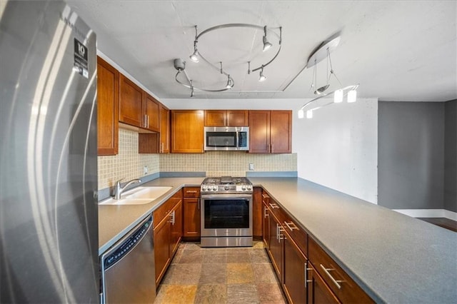 kitchen featuring tasteful backsplash, stainless steel appliances, kitchen peninsula, and sink