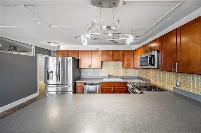 kitchen featuring appliances with stainless steel finishes, sink, and backsplash