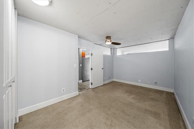 interior space with carpet floors and ceiling fan