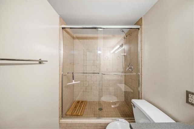 bathroom featuring an enclosed shower and toilet