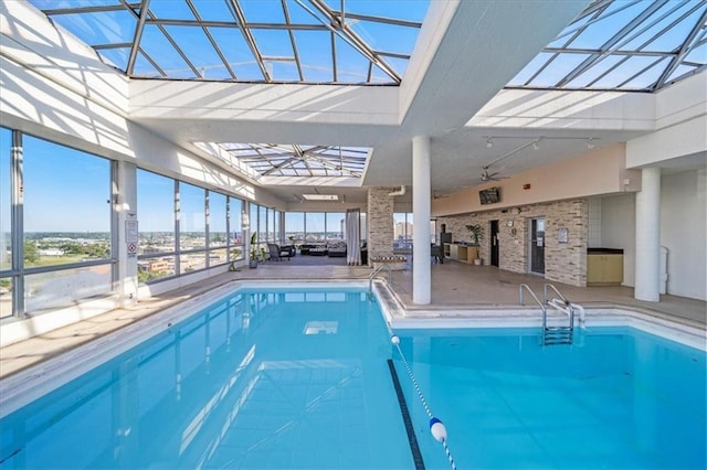 view of pool featuring a lanai, ceiling fan, and a patio area